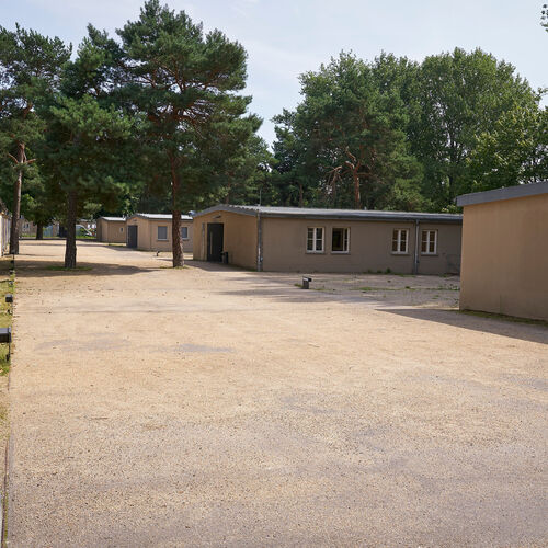 The former barracks of the Schöneweide forced labour camp stand on the bare ground.